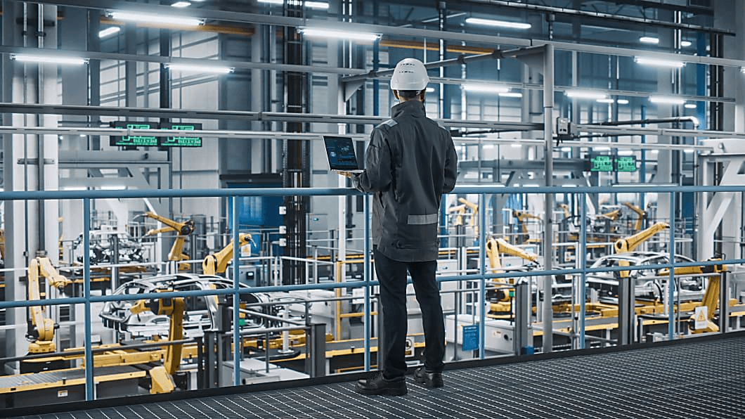 Engineer overlooking automated factory floor